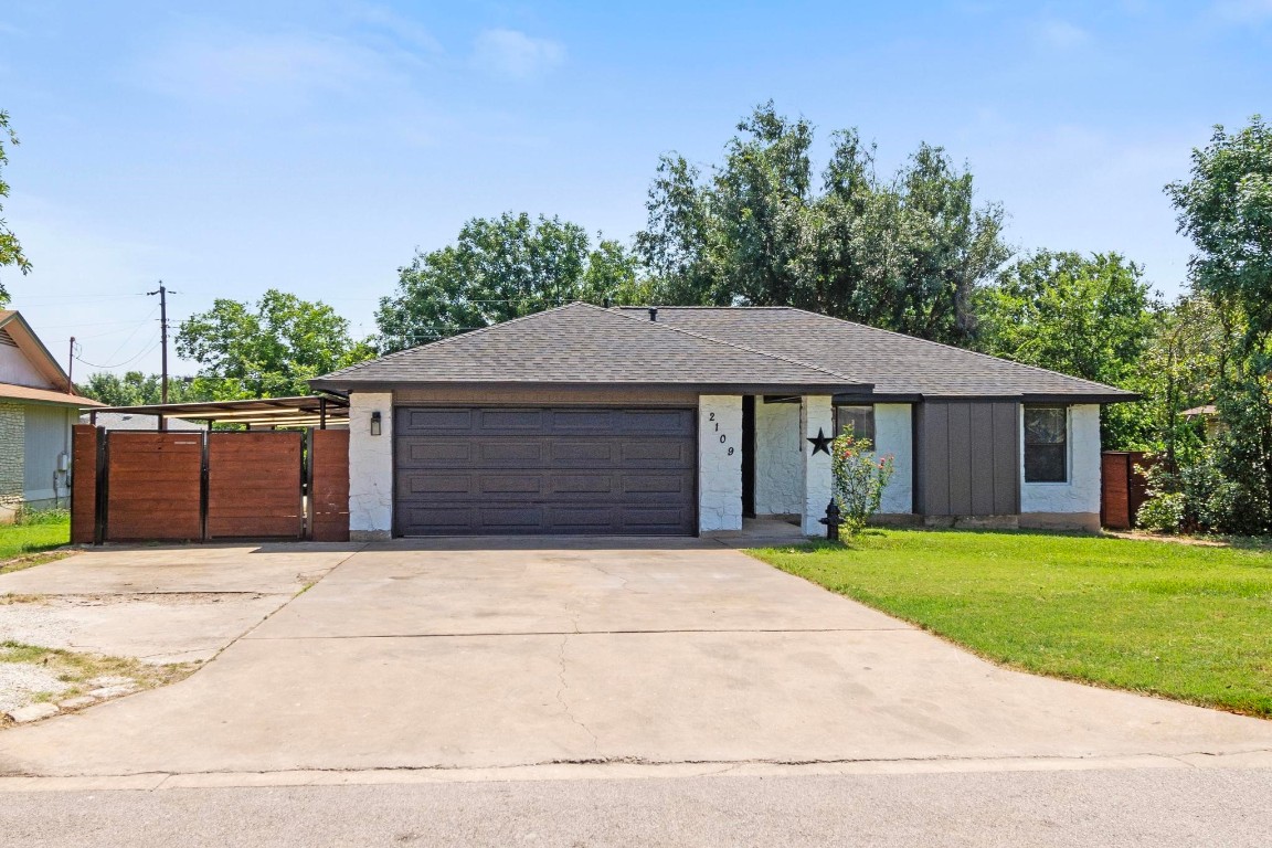 a front view of a house with a yard and garage