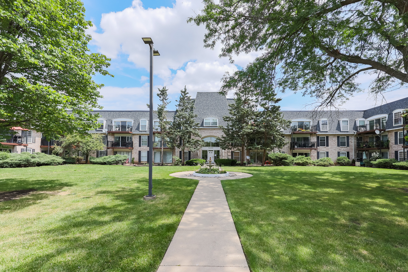 a view of a park with a house in the background