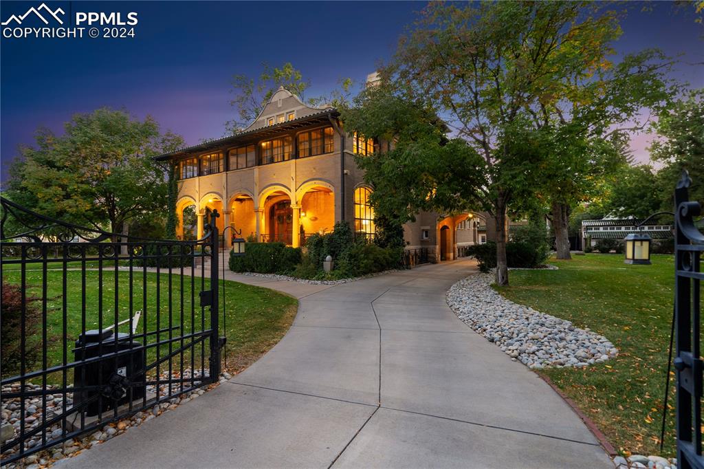 The Sharp Mansion, enter through the stately gate to the alley or stop under the arched porte cochere