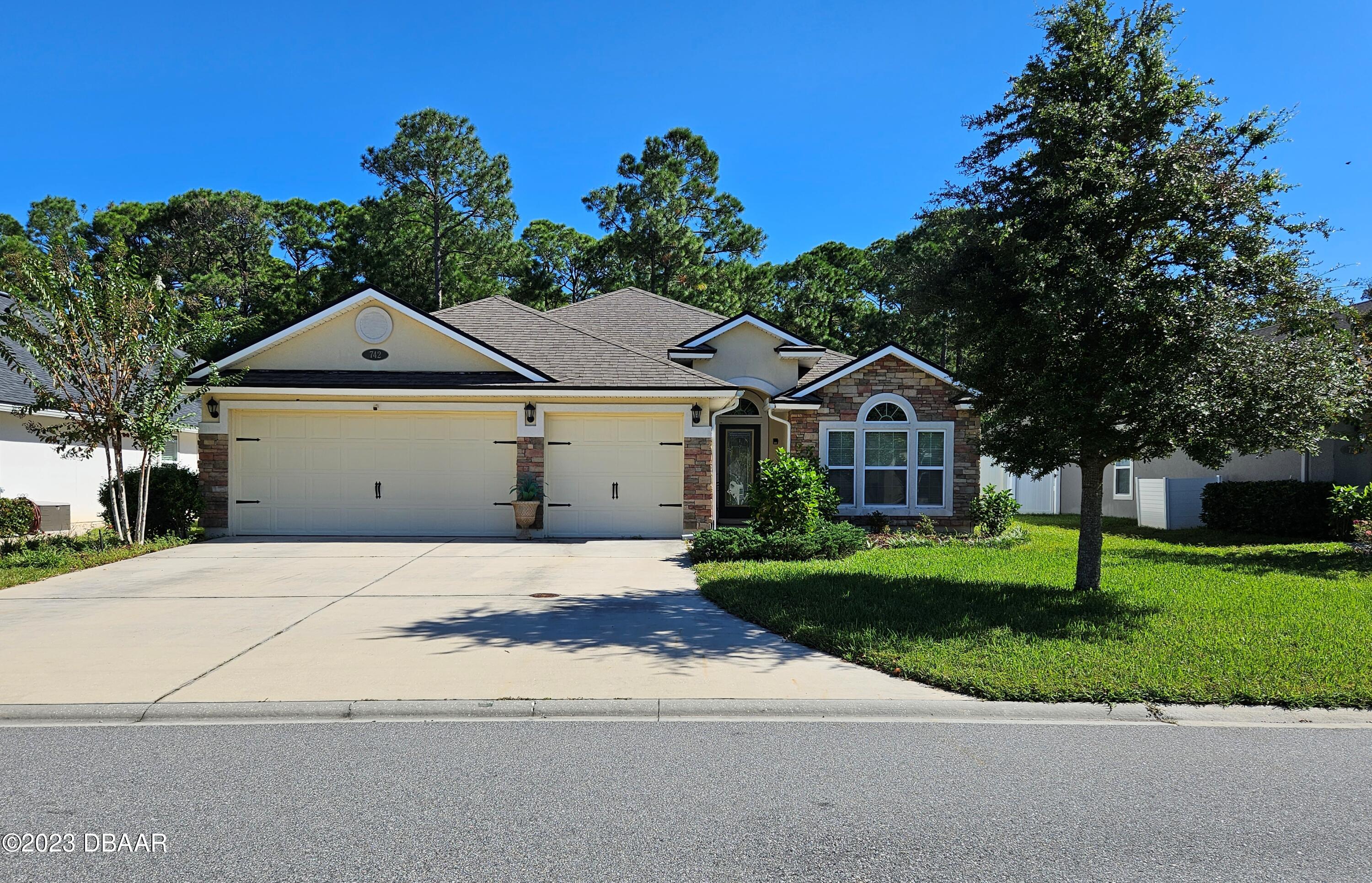 a front view of a house with a yard