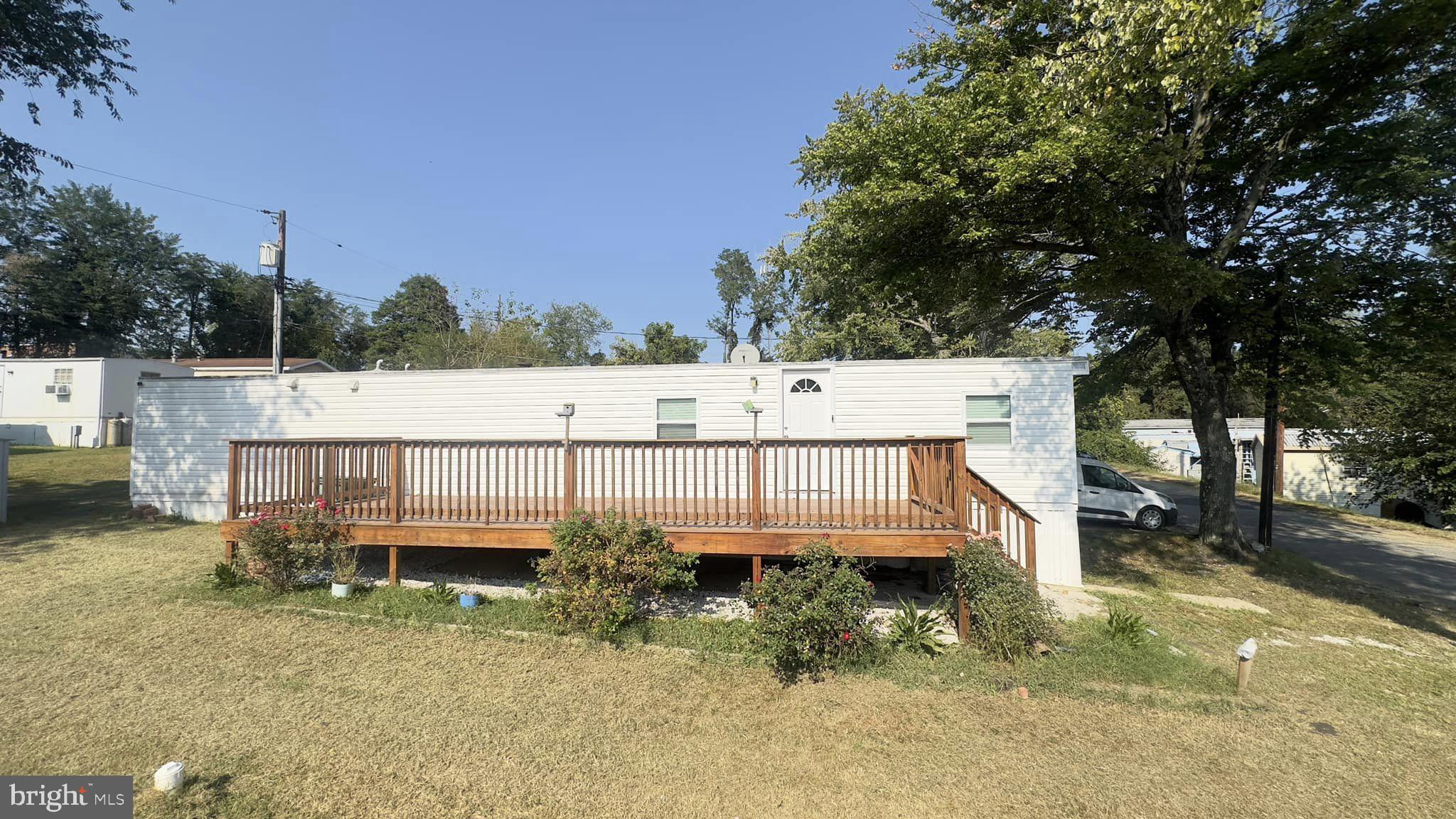 a view of a house with wooden floor and fence