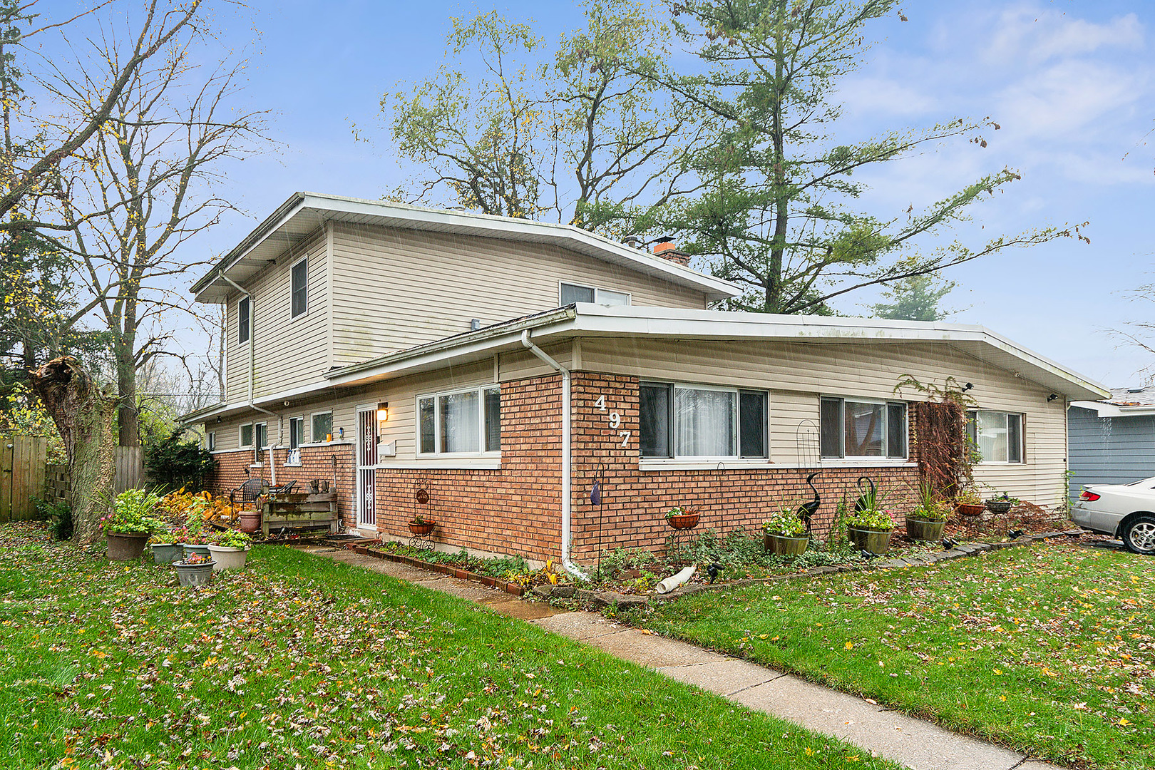 a front view of a house with a yard and porch