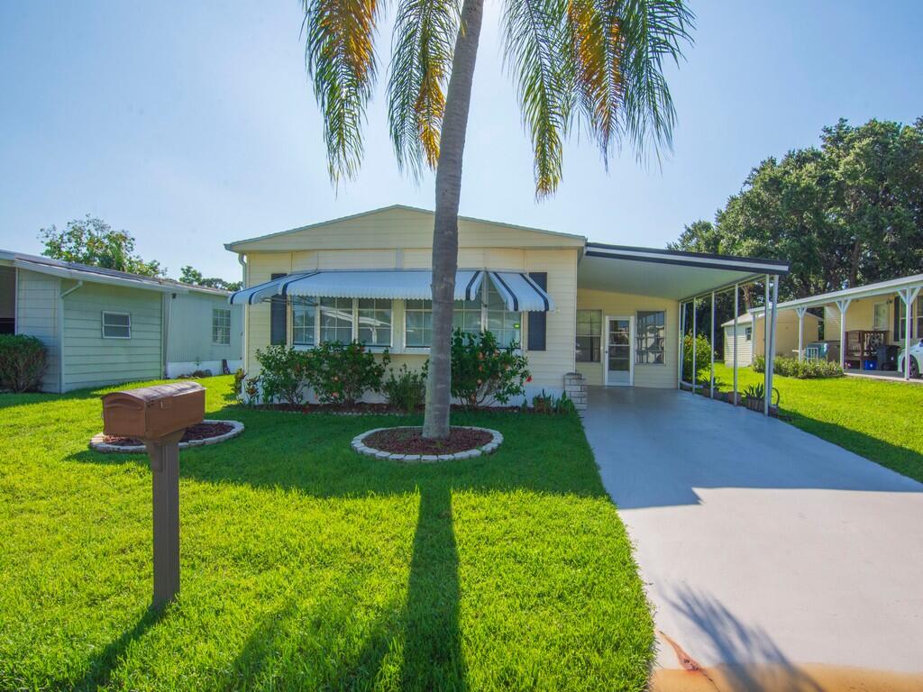 a front view of house with yard patio and green space