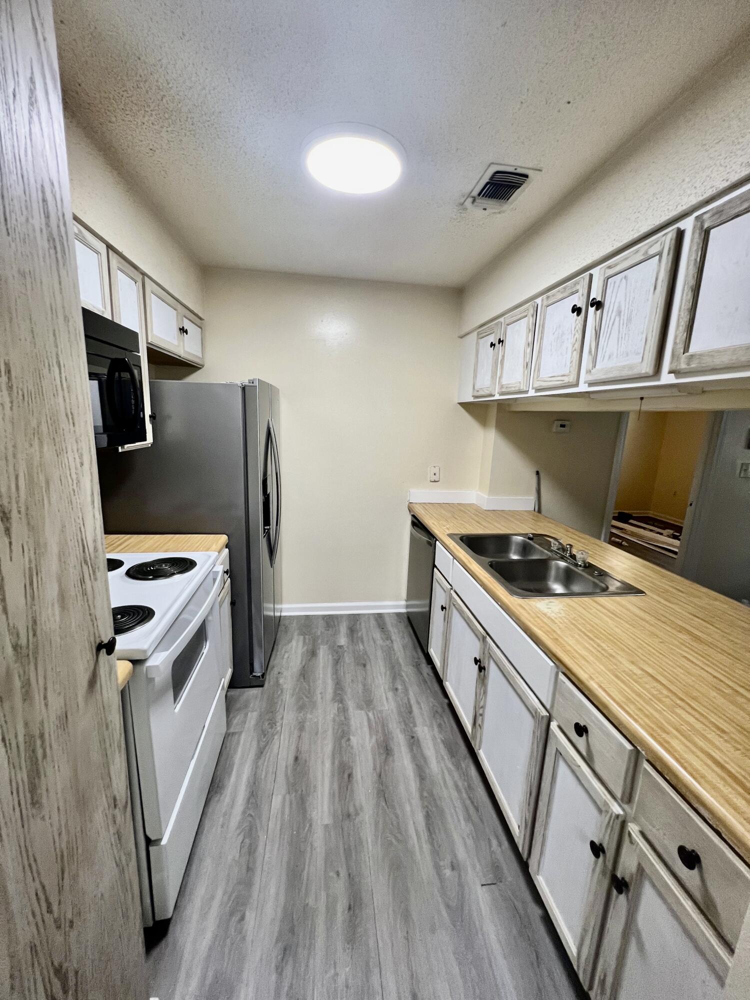 a kitchen with stainless steel appliances granite countertop a stove and a refrigerator