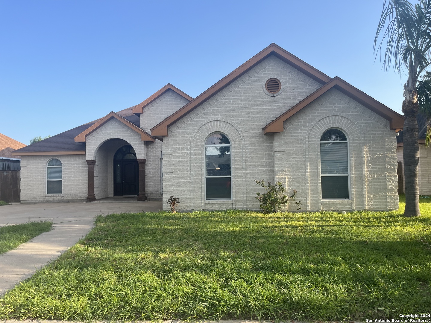 a front view of house with yard and green space