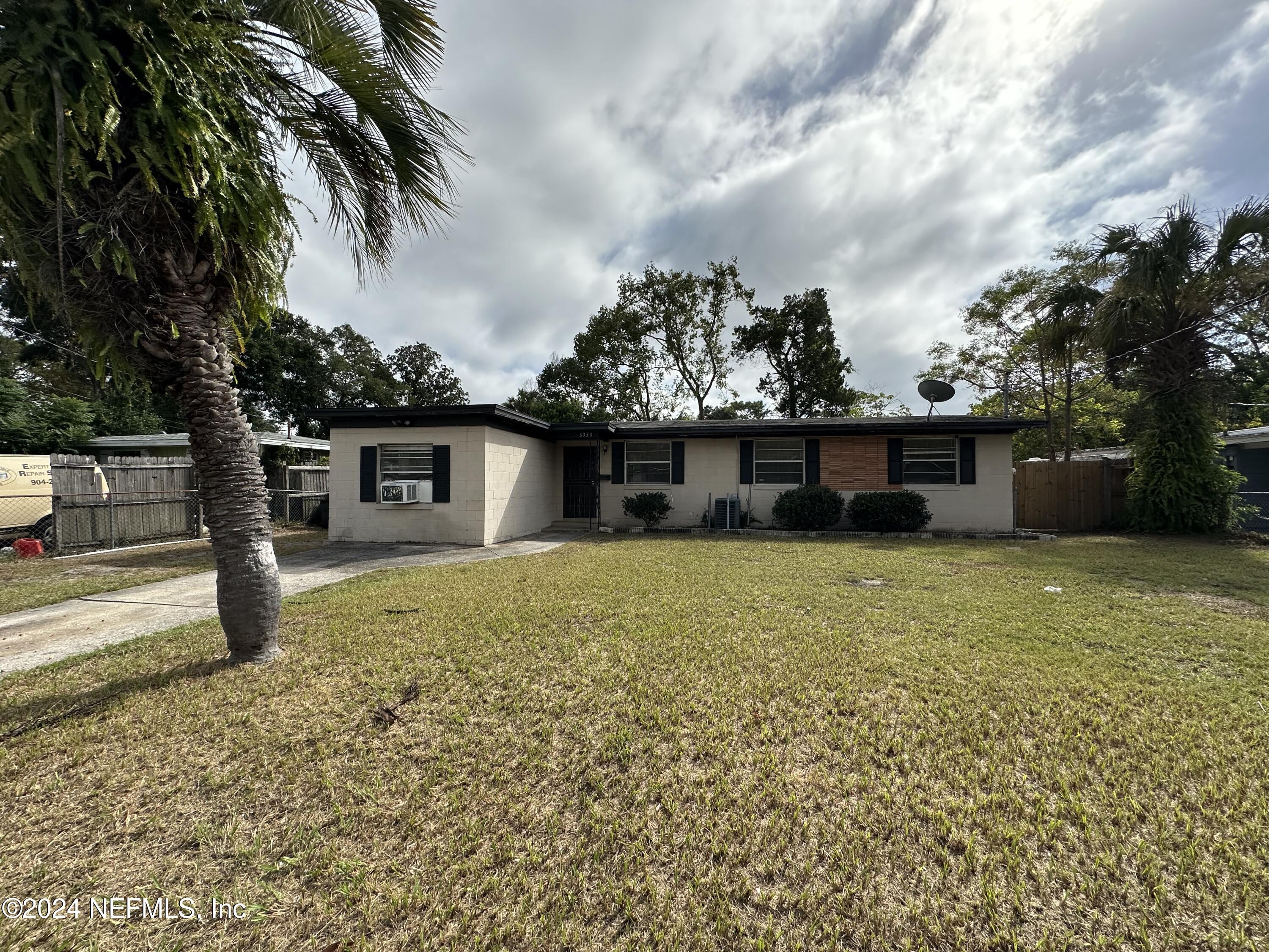 a front view of a house with a garden and yard