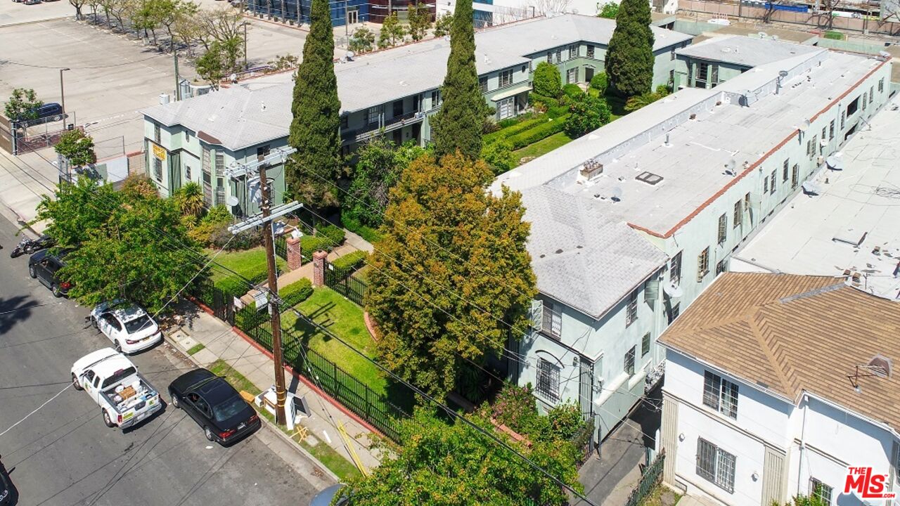 an aerial view of a house with a yard wooden table and chairs