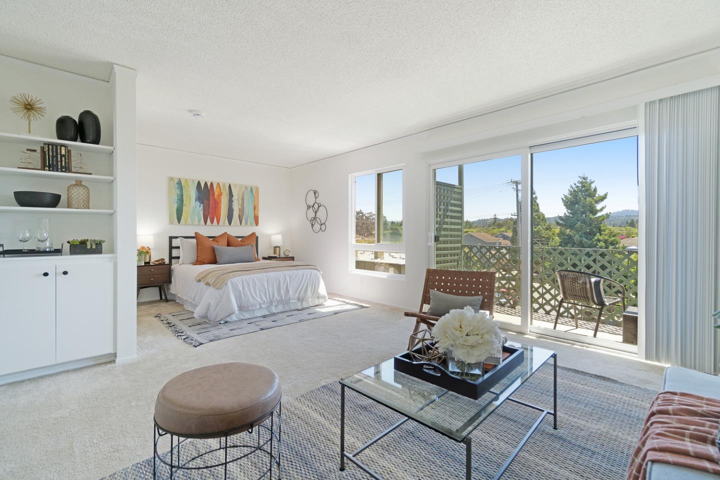 a living room with furniture and a floor to ceiling window