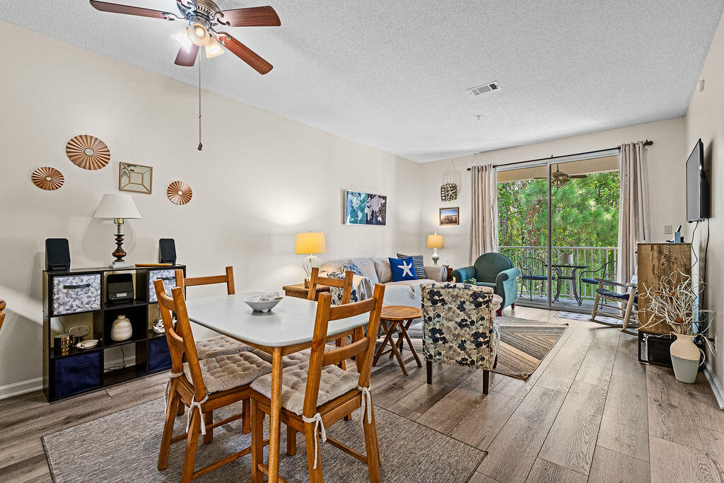 a dining room with furniture and a large window