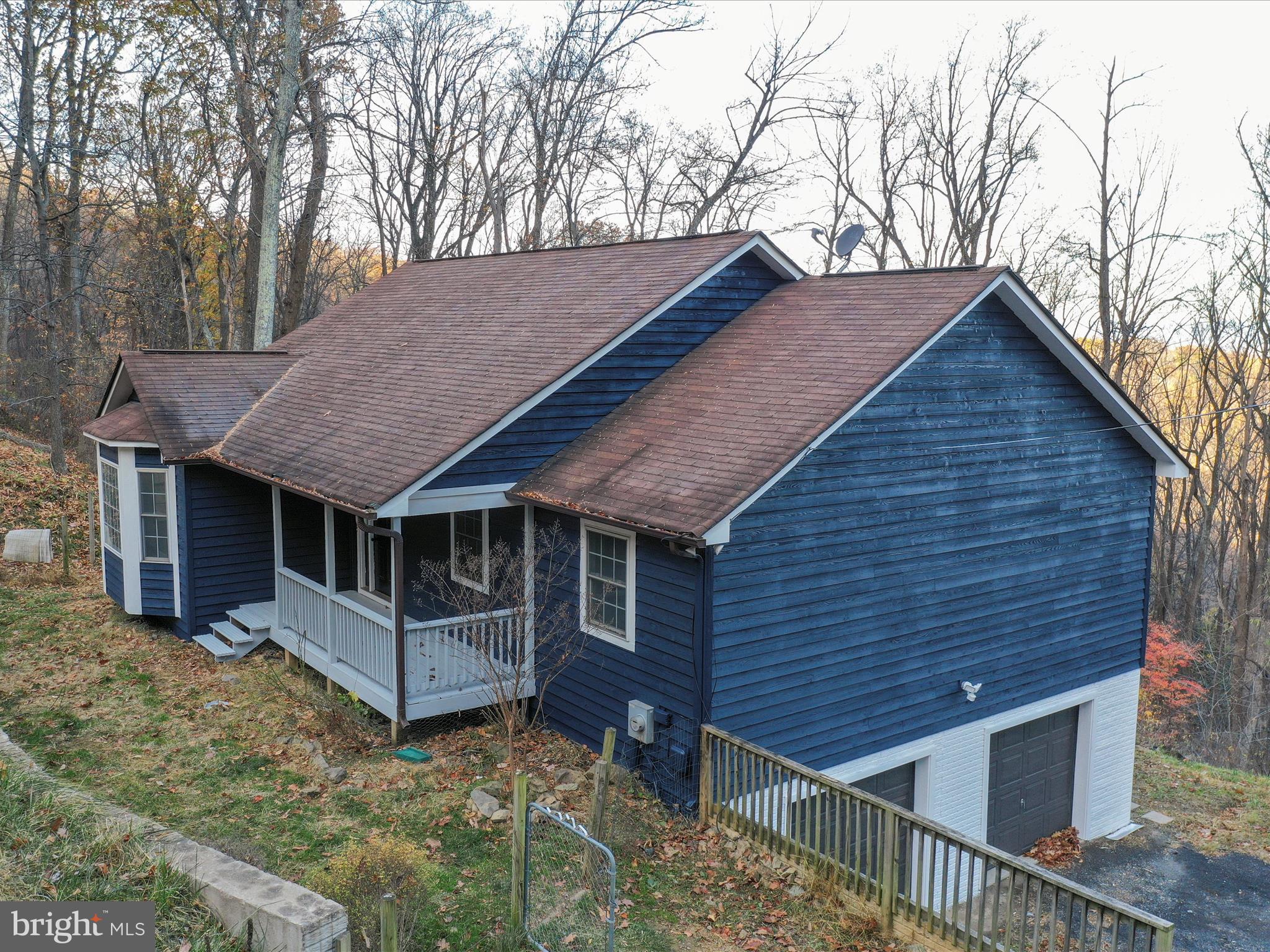 a view of house with a yard and wooden fence