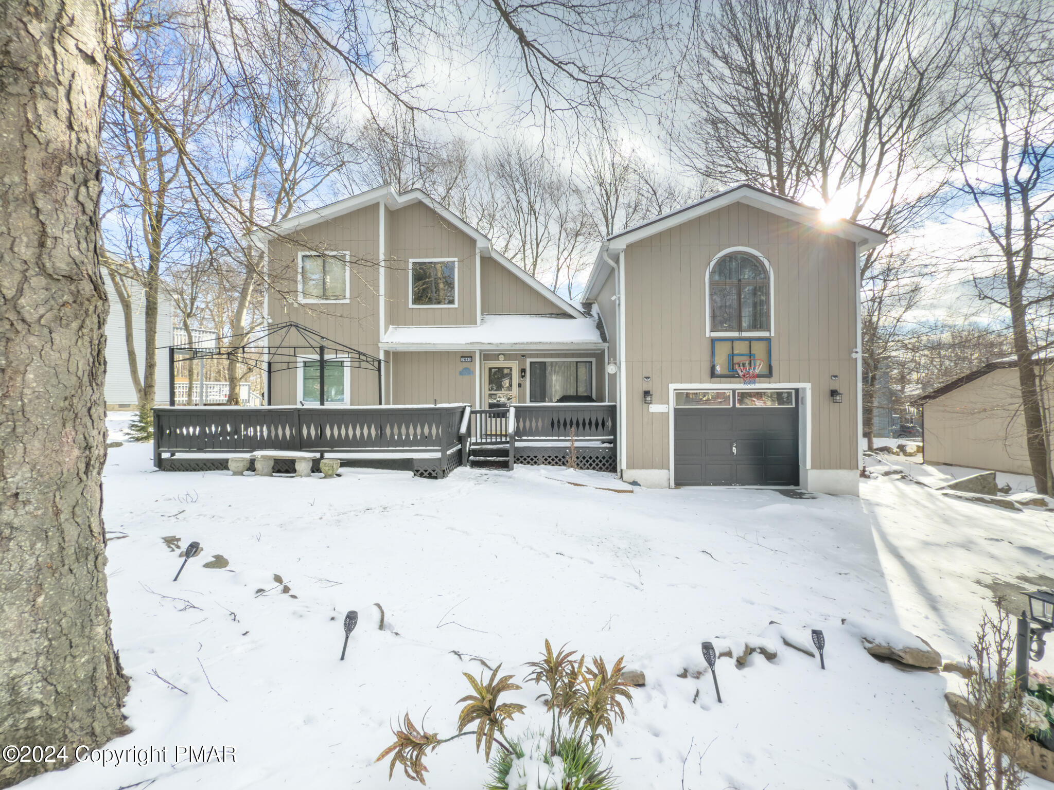 a front view of a house with yard covered in snow