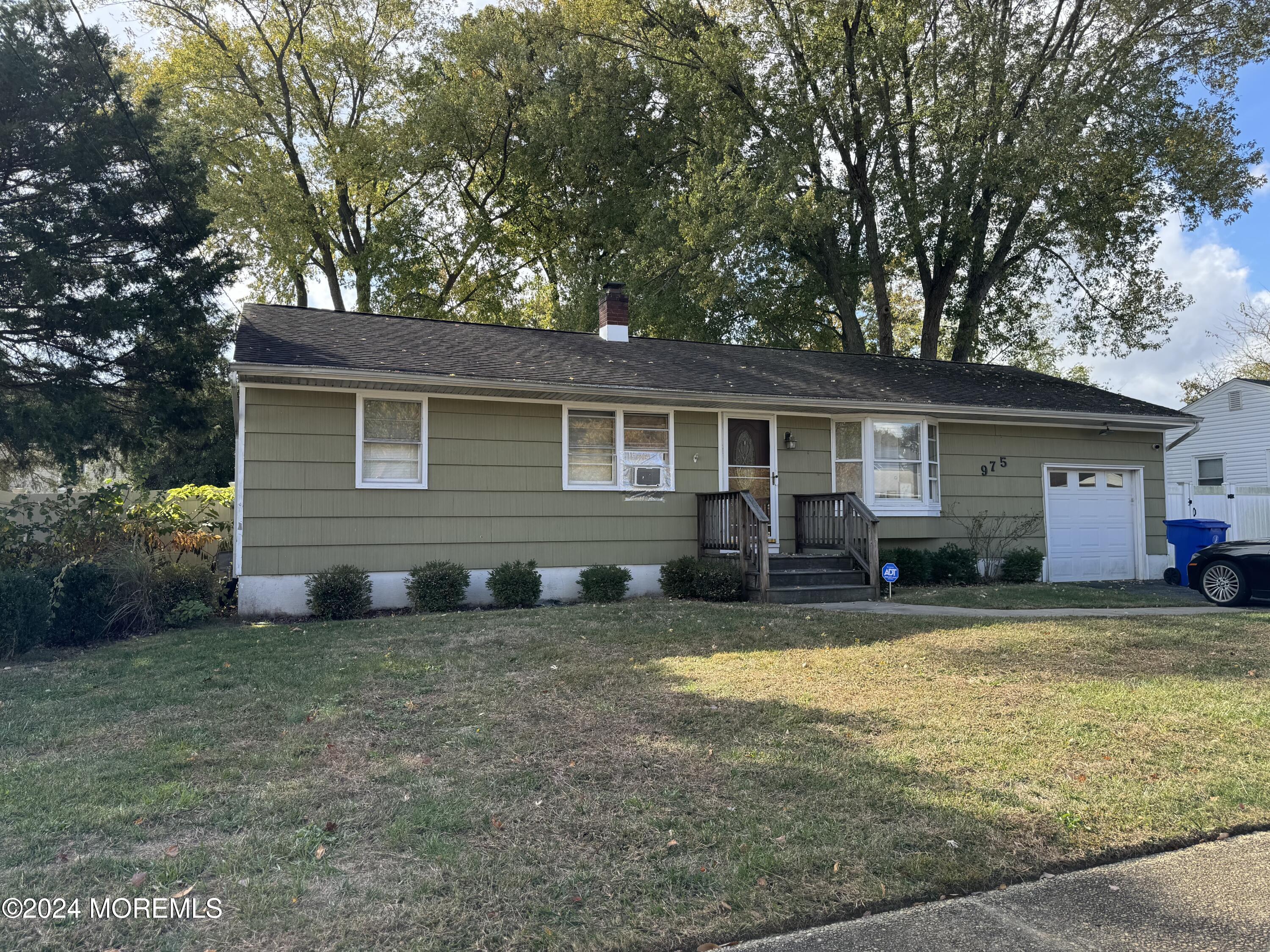 a view of a house with a yard and sitting area