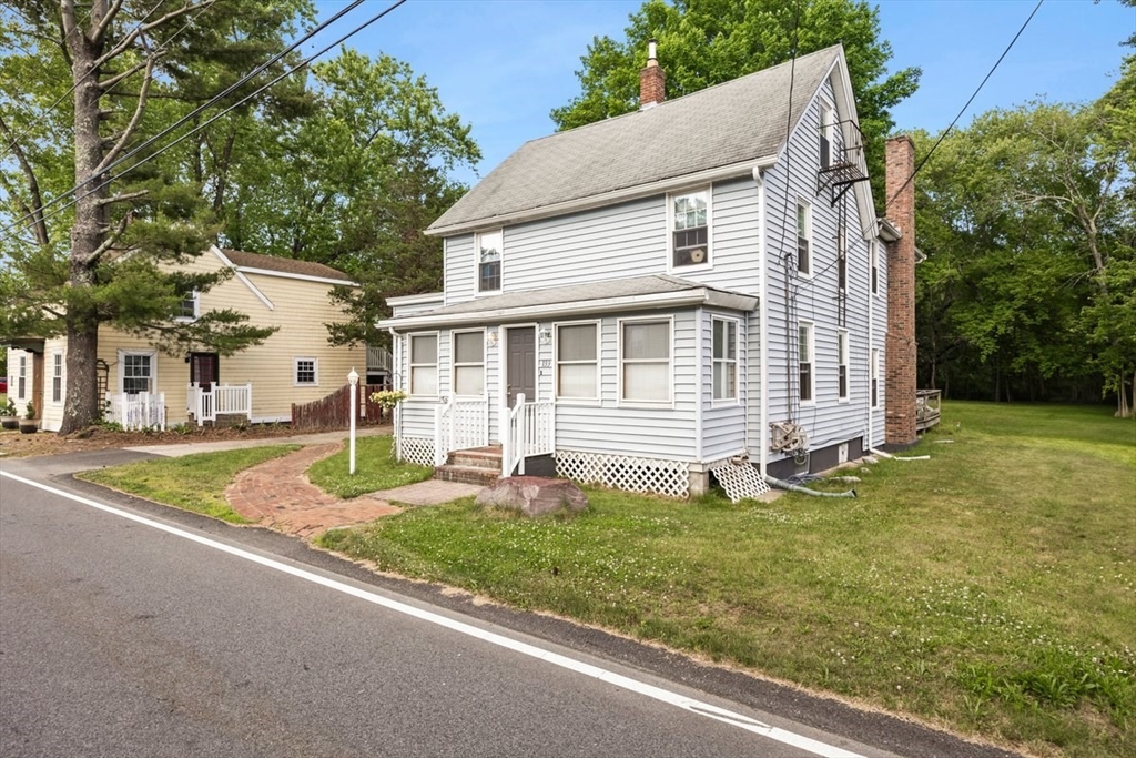 a front view of a house with a yard