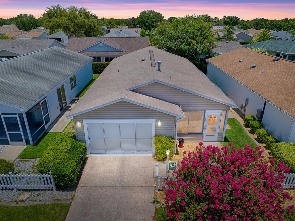 a aerial view of a house with a yard and potted plants