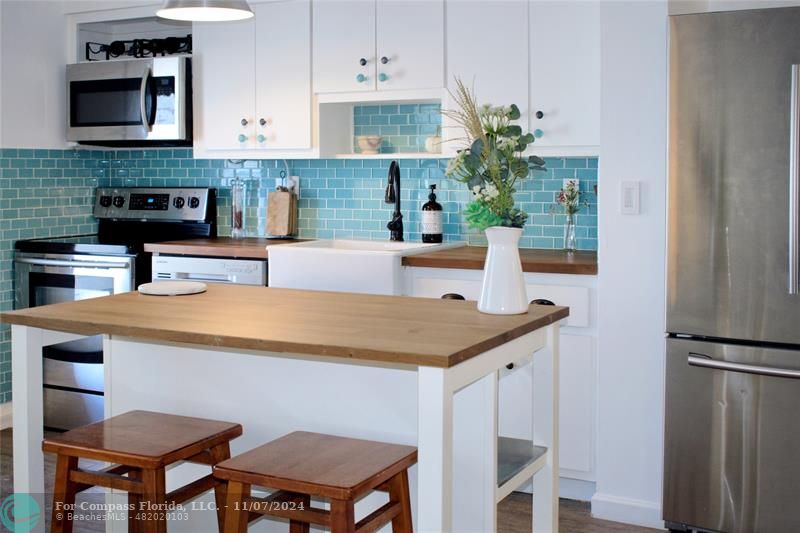 a kitchen with a table chairs and a refrigerator