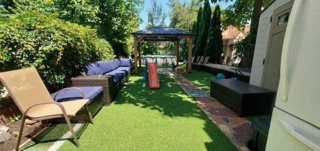 a view of a chairs in backyard of the house