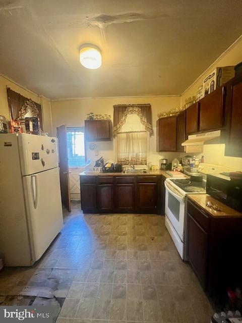 a kitchen with granite countertop a sink a counter space and cabinets