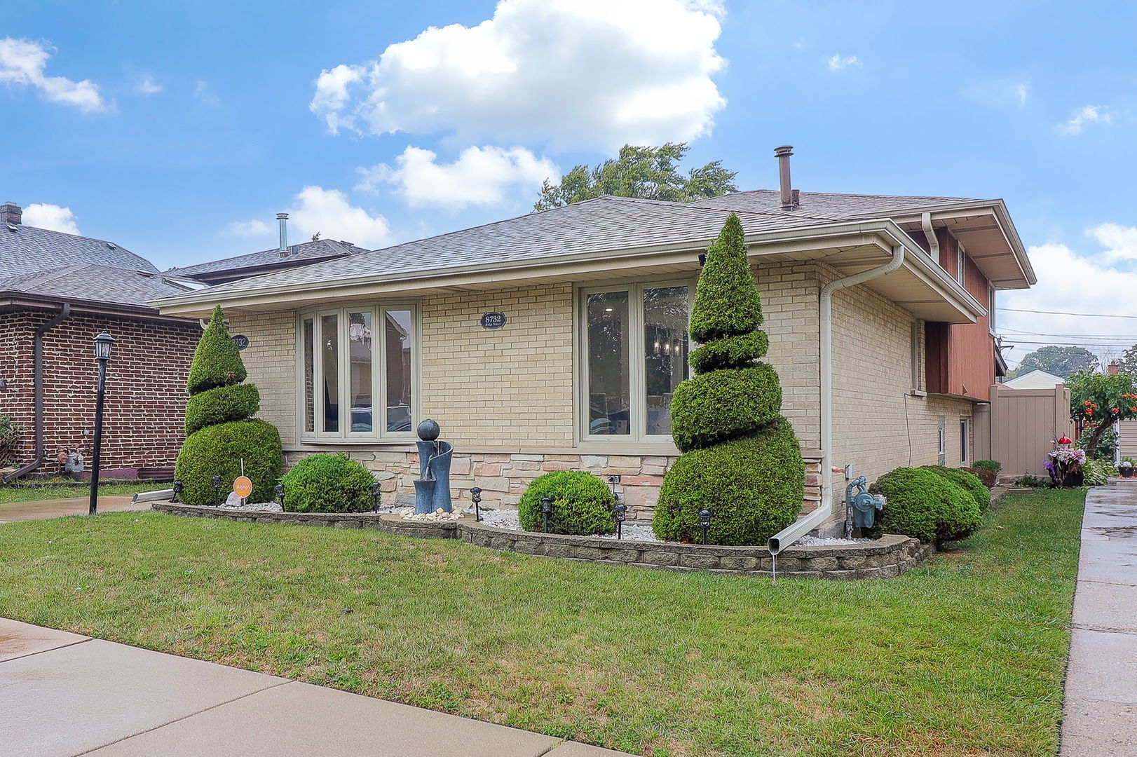 a view of a house with a yard and plants