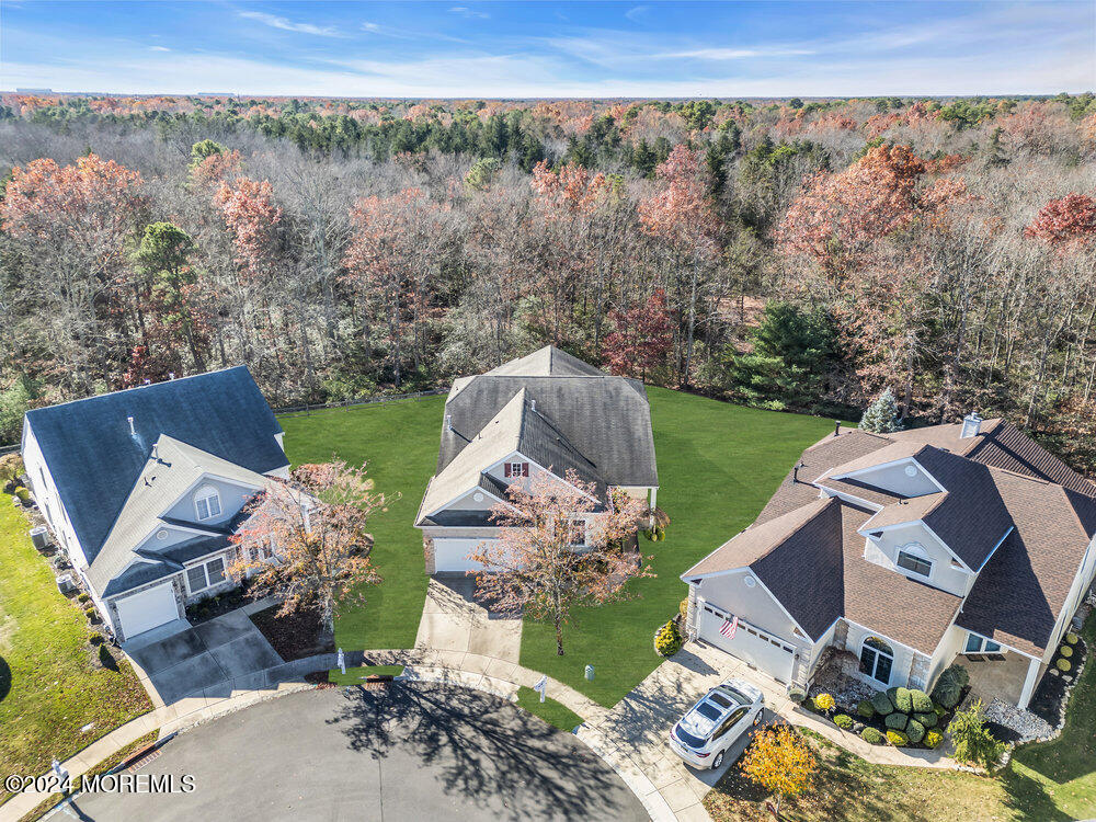 an aerial view of a house with garden space and outdoor seating