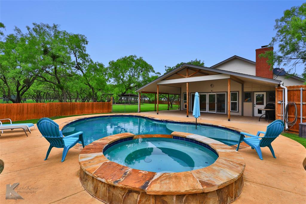 a view of swimming pool with a lounge chair