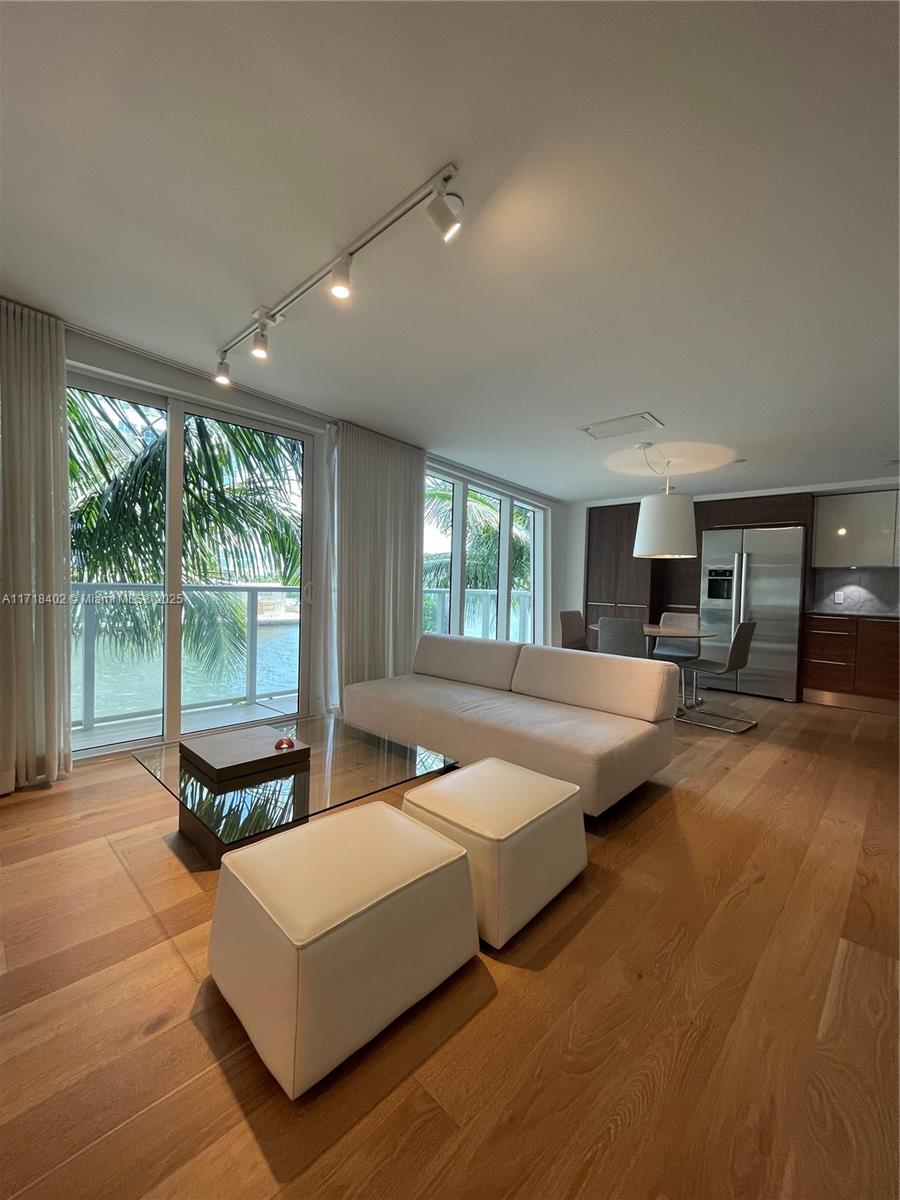 a living room with furniture and large windows