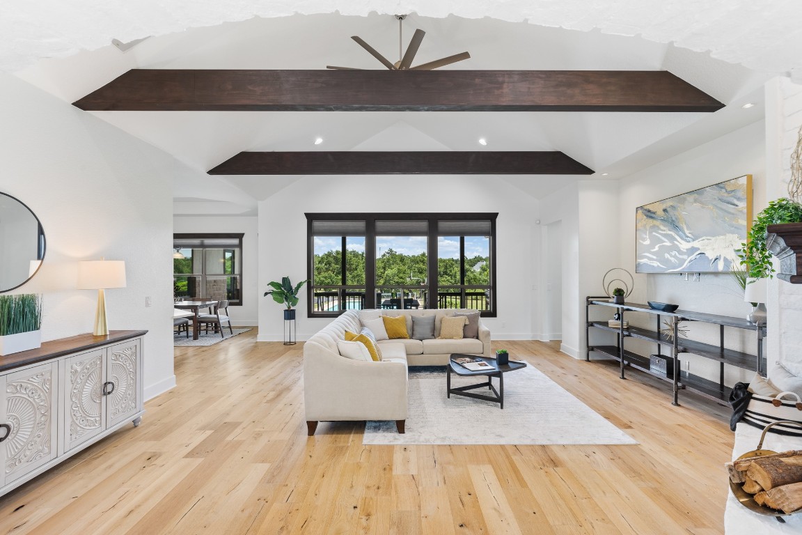 a living room with furniture and a wooden floor