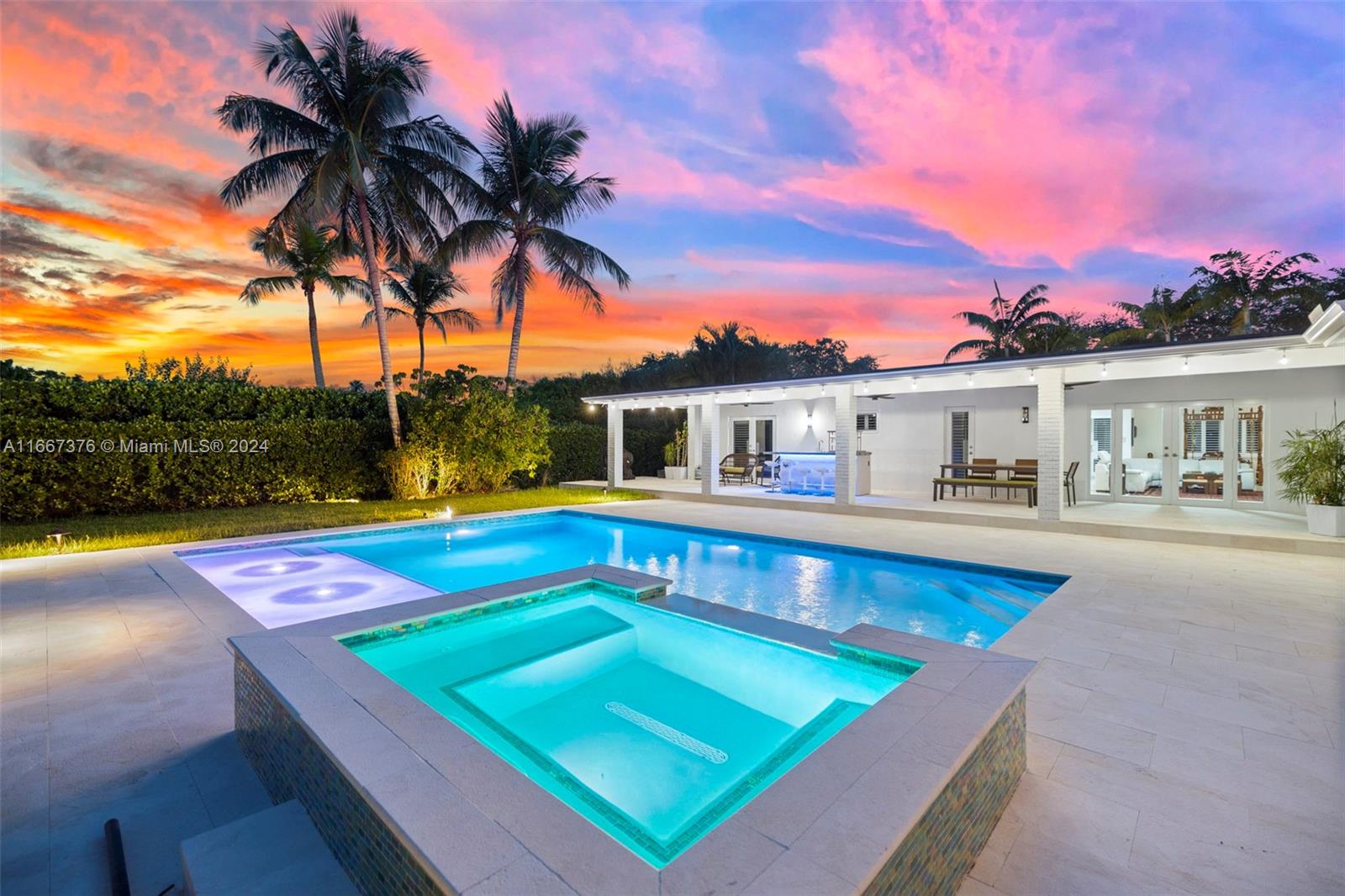 a view of swimming pool with a lounge chair and palm trees