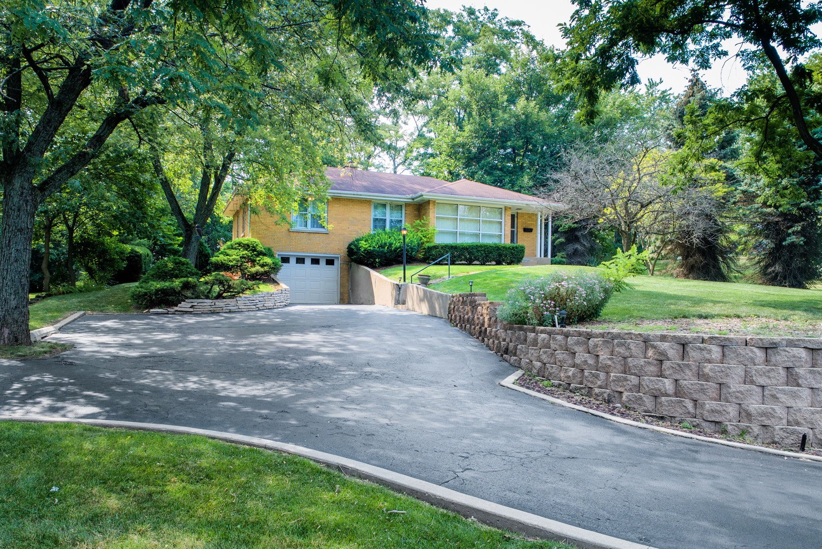 a front view of a house with a yard and a garage