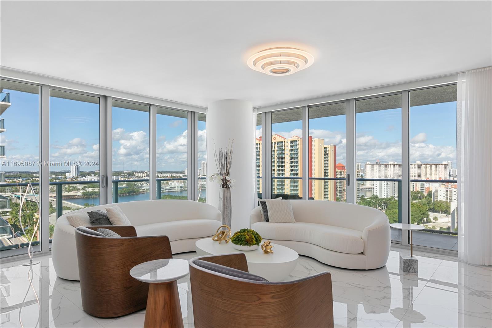 a living room with furniture and a floor to ceiling window