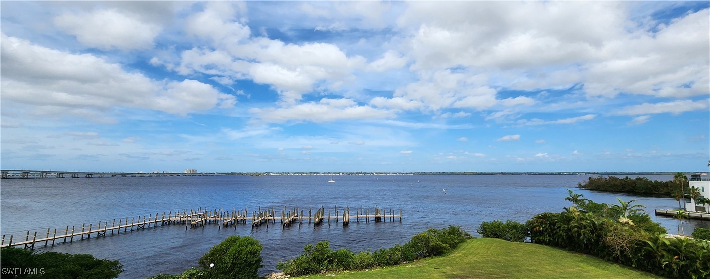 a view of a lake with houses in back