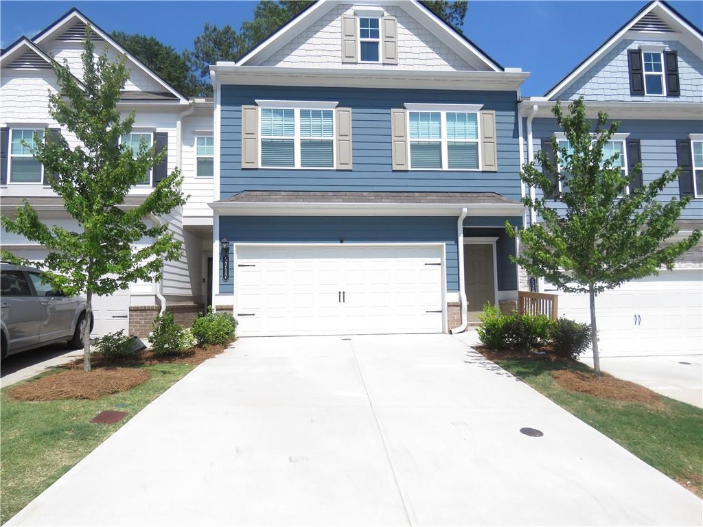 a front view of a house with a yard and garage