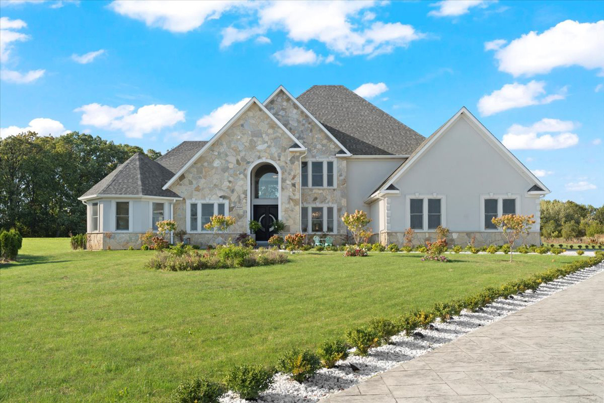 a front view of a house with a yard