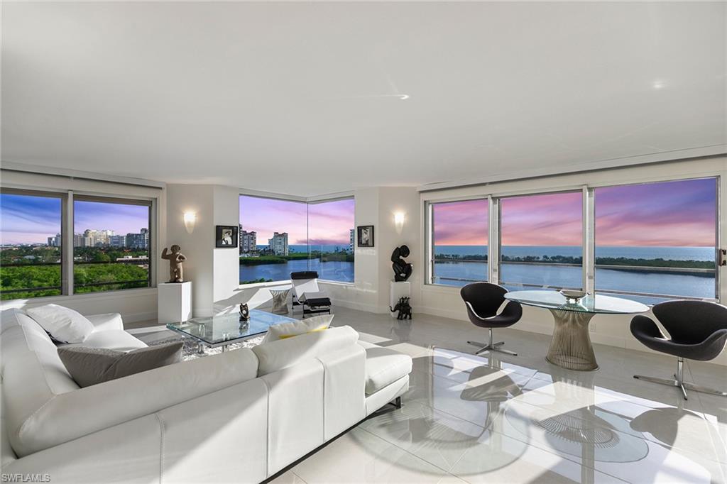 a living room with furniture and a floor to ceiling window