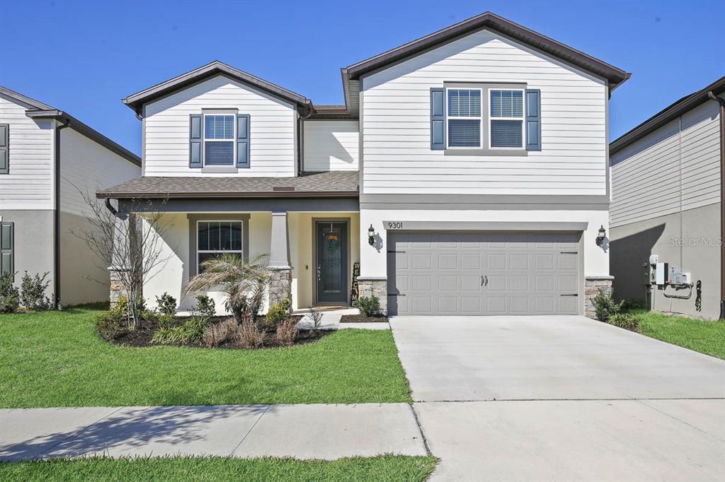 a front view of a house with a yard and garage