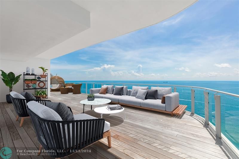 a balcony with furniture and wooden floor