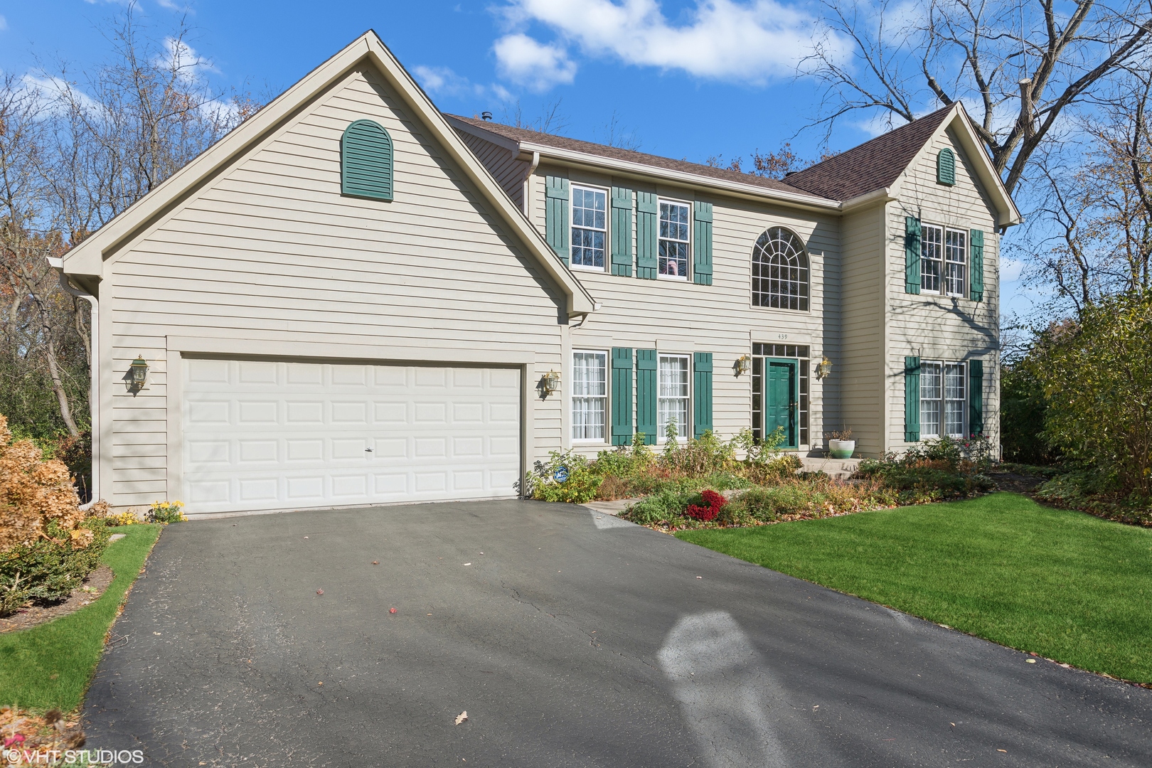 a front view of house with yard and green space