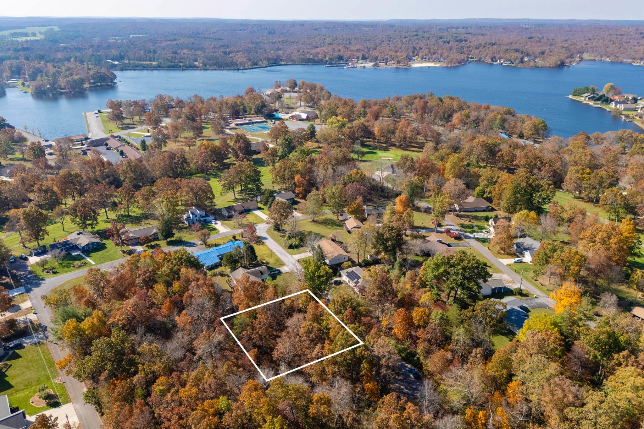 an aerial view of house with yard and lake view