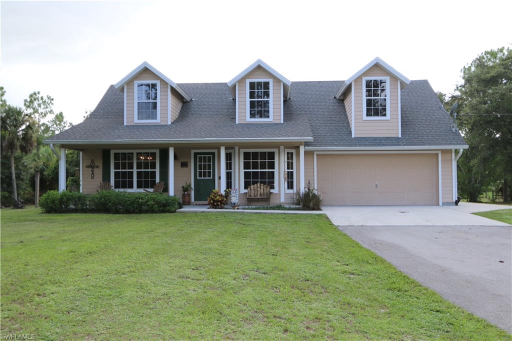 a front view of a house with a garden and porch