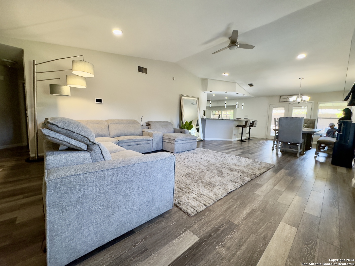 a living room with furniture and a wooden floor