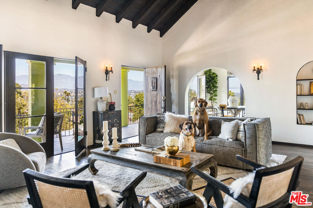 a living room with furniture and floor to ceiling windows