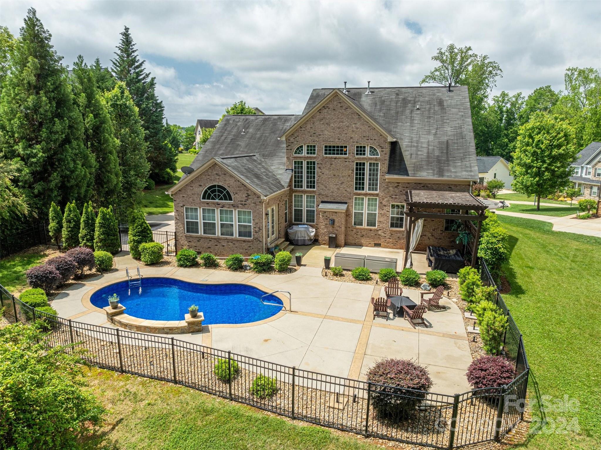 a view of house with swimming pool outdoor seating and yard