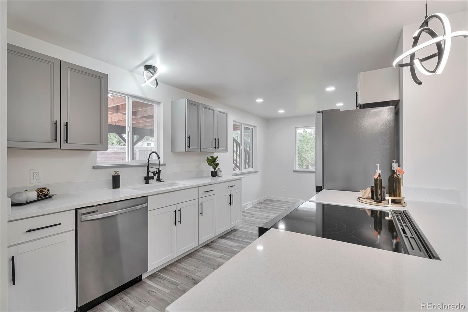 a kitchen with a sink stove and cabinets