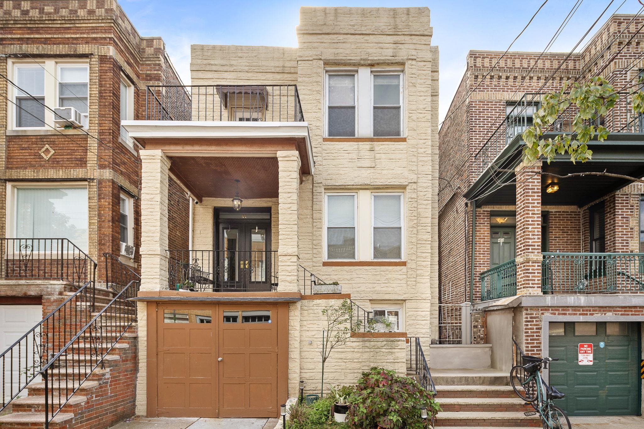 a front view of a residential apartment building with a yard