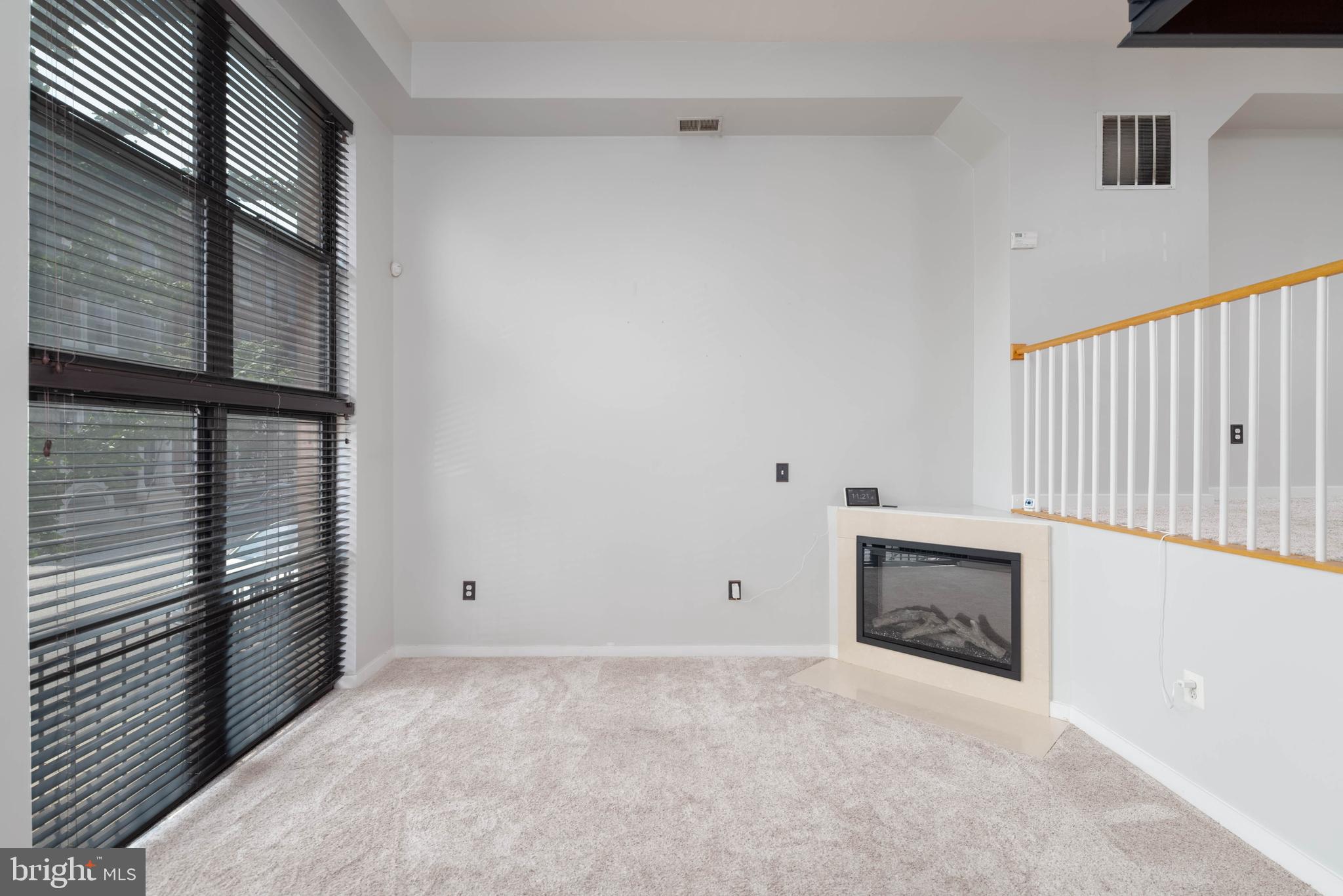 a view of empty room with fireplace