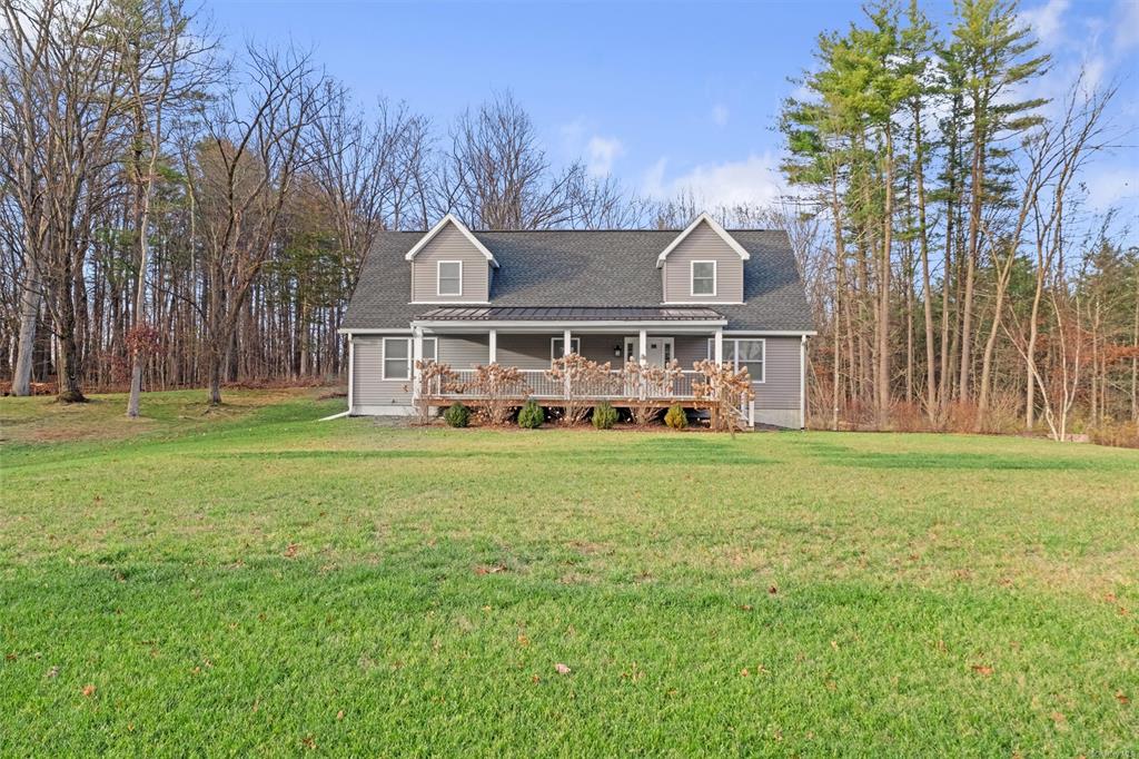 Cape cod-style house featuring a front lawn