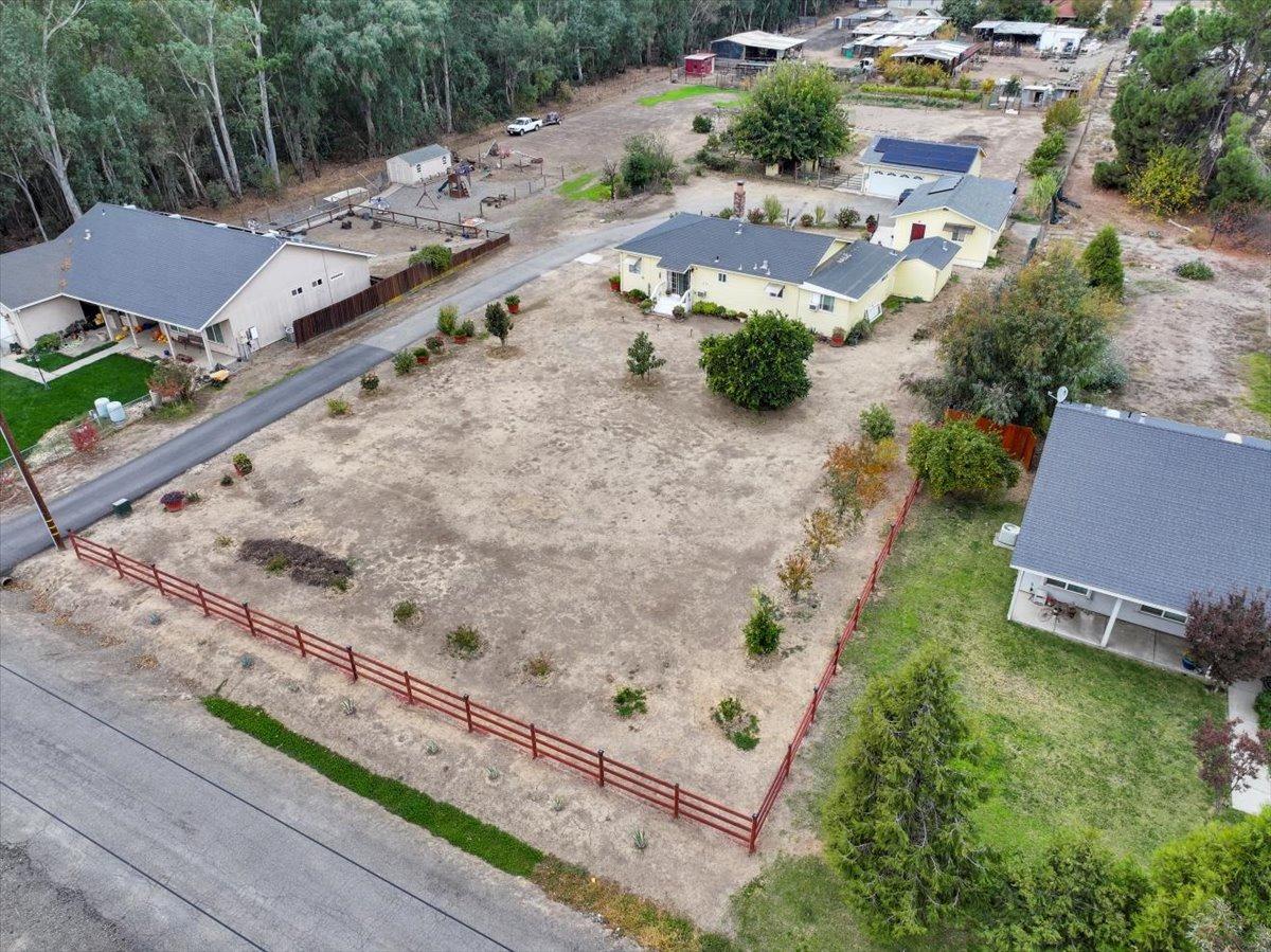 an aerial view of a house with a yard and lake view