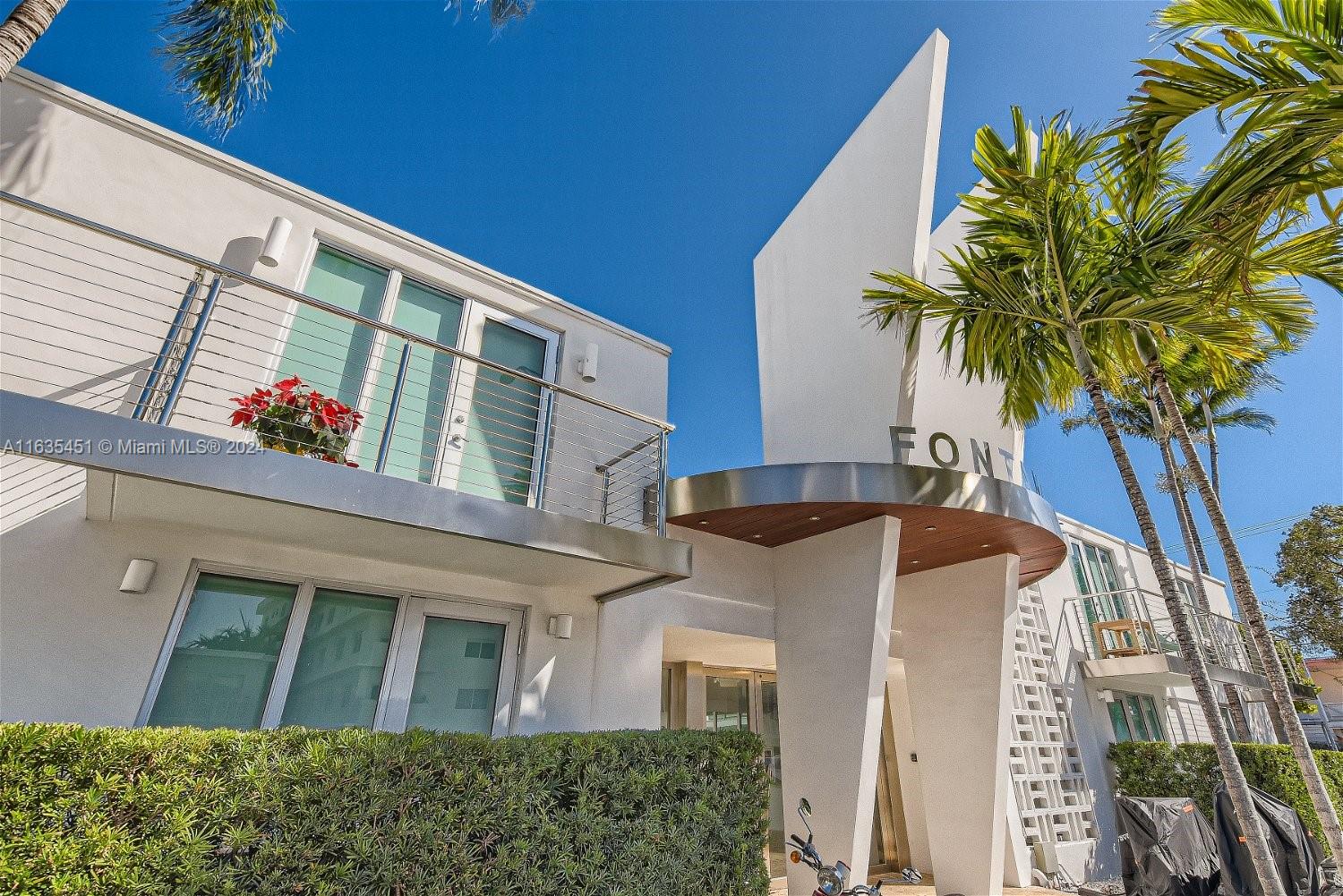 a front view of house with a palm tree