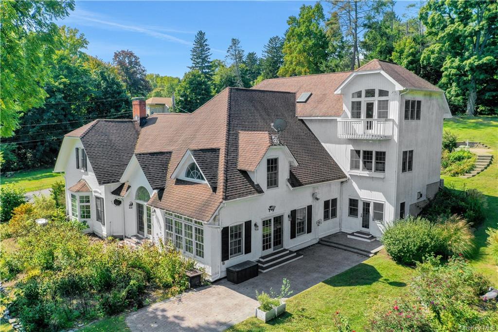 an aerial view of a house with a yard and potted plants