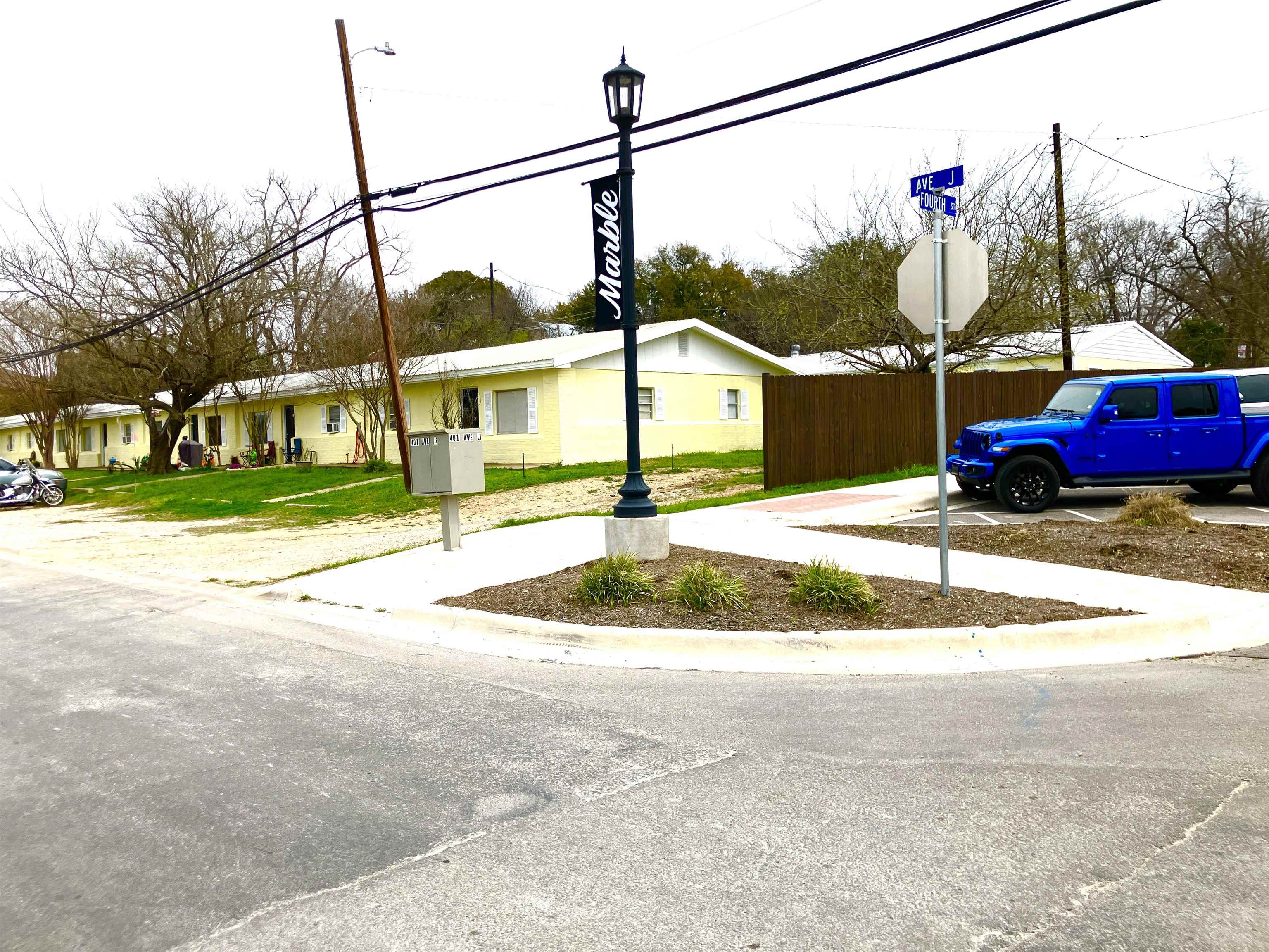 a view of a house with a backyard and road