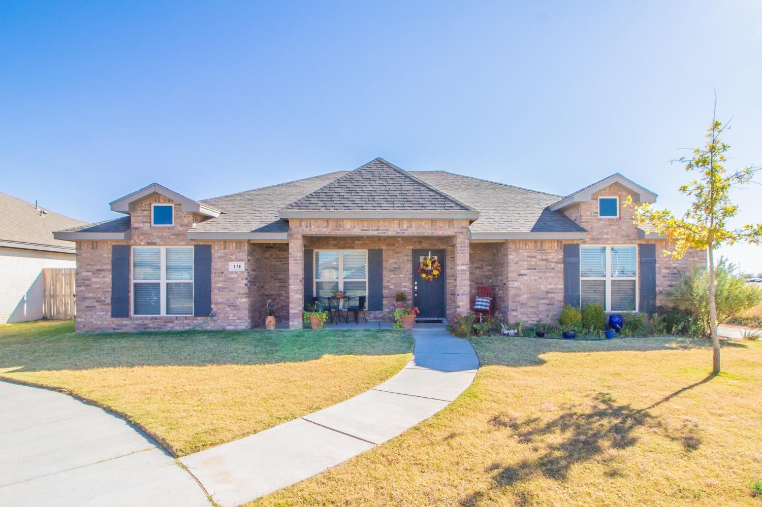 a front view of a house with a yard and porch